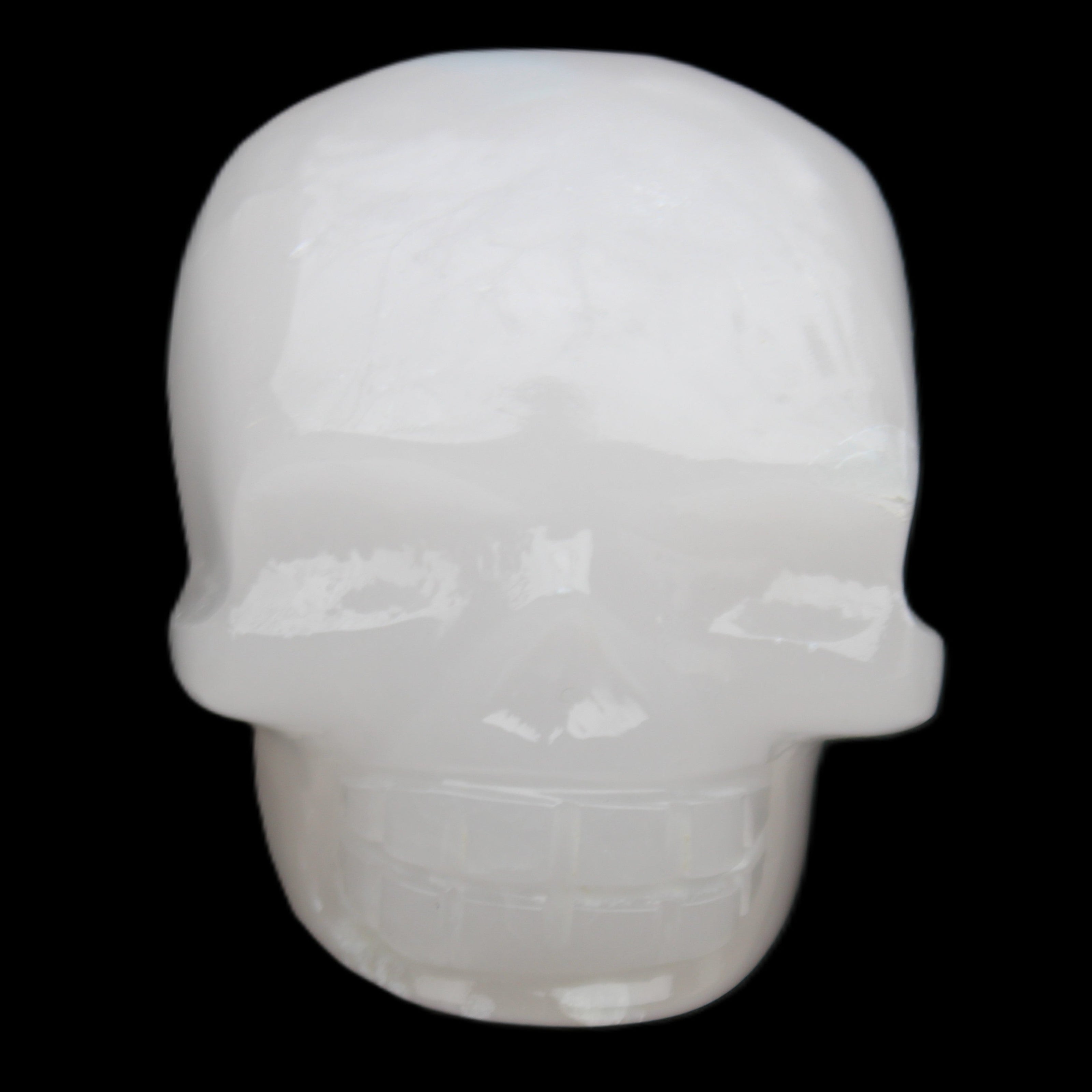Mangano Calcite skull 45*52*48mm 196g in sunlight - Rocks and Things Store