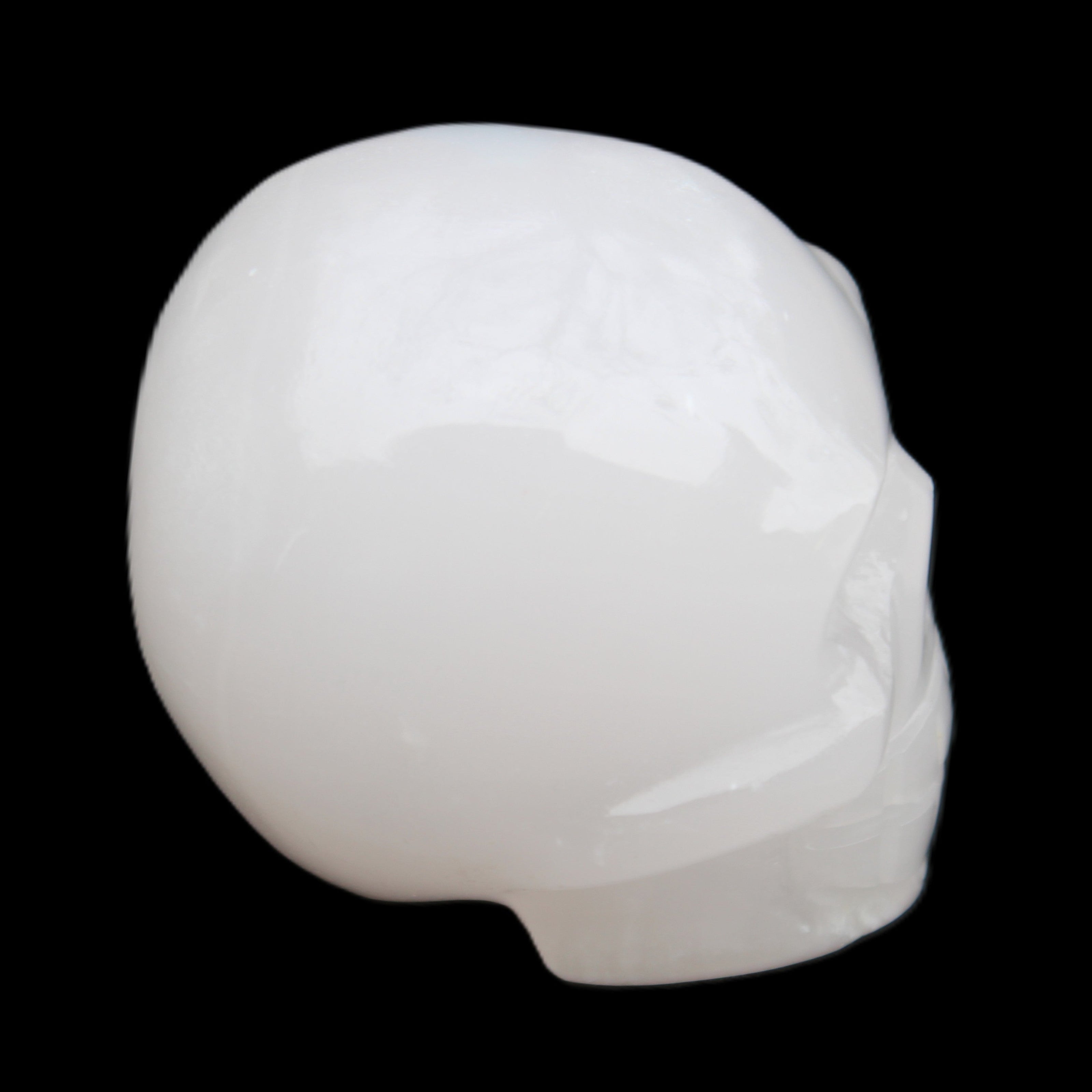 Mangano Calcite skull 45*52*48mm 196g in sunlight - Rocks and Things Store