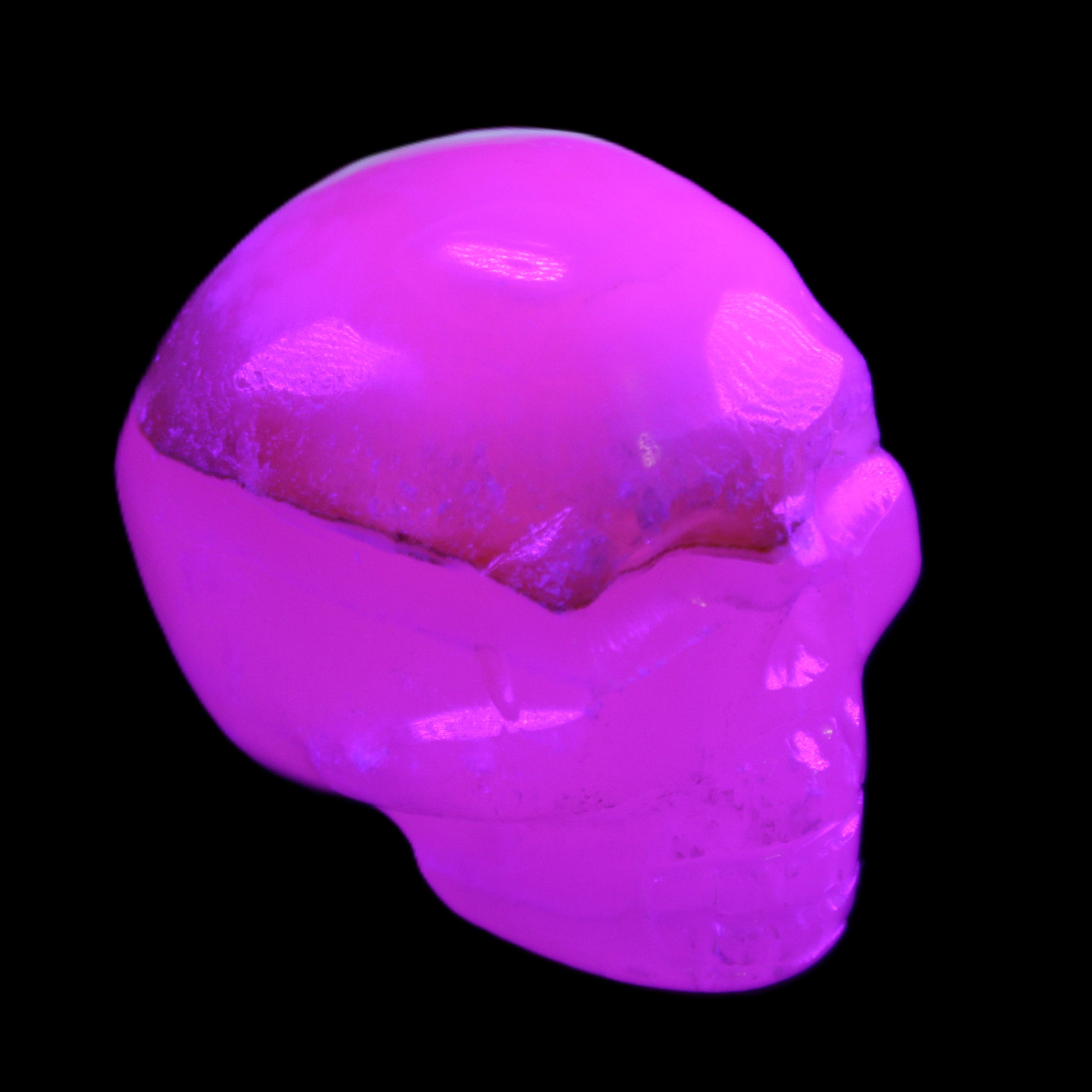Mangano Calcite skull 38*55*48mm 167g in UV light - Rocks and Things Store