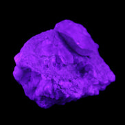 Quartz crystals in Feldspar matrix from Pakistan 313.8ct 62.8g in UV light - Rocks and Things Store