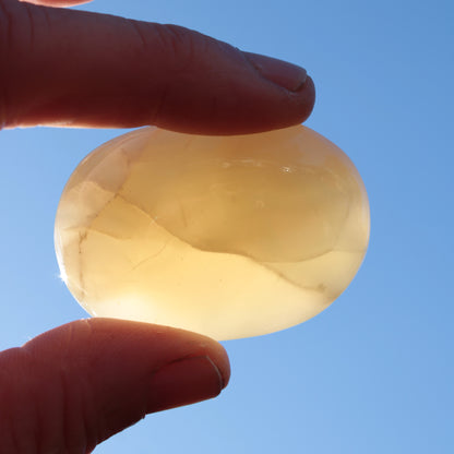 Honey Calcite palm stone from Pakistan 71.7g Rocks and Things