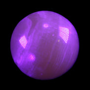 Honey Calcite sphere 176g in UV light - Rocks and Things Store