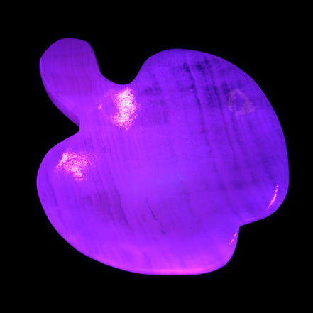 Mangano Calcite hand-carved apple 50-59g in UV light - Rocks and Things Store