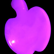 Mangano Calcite hand-carved apple 50-59g in UV light - Rocks and Things Store