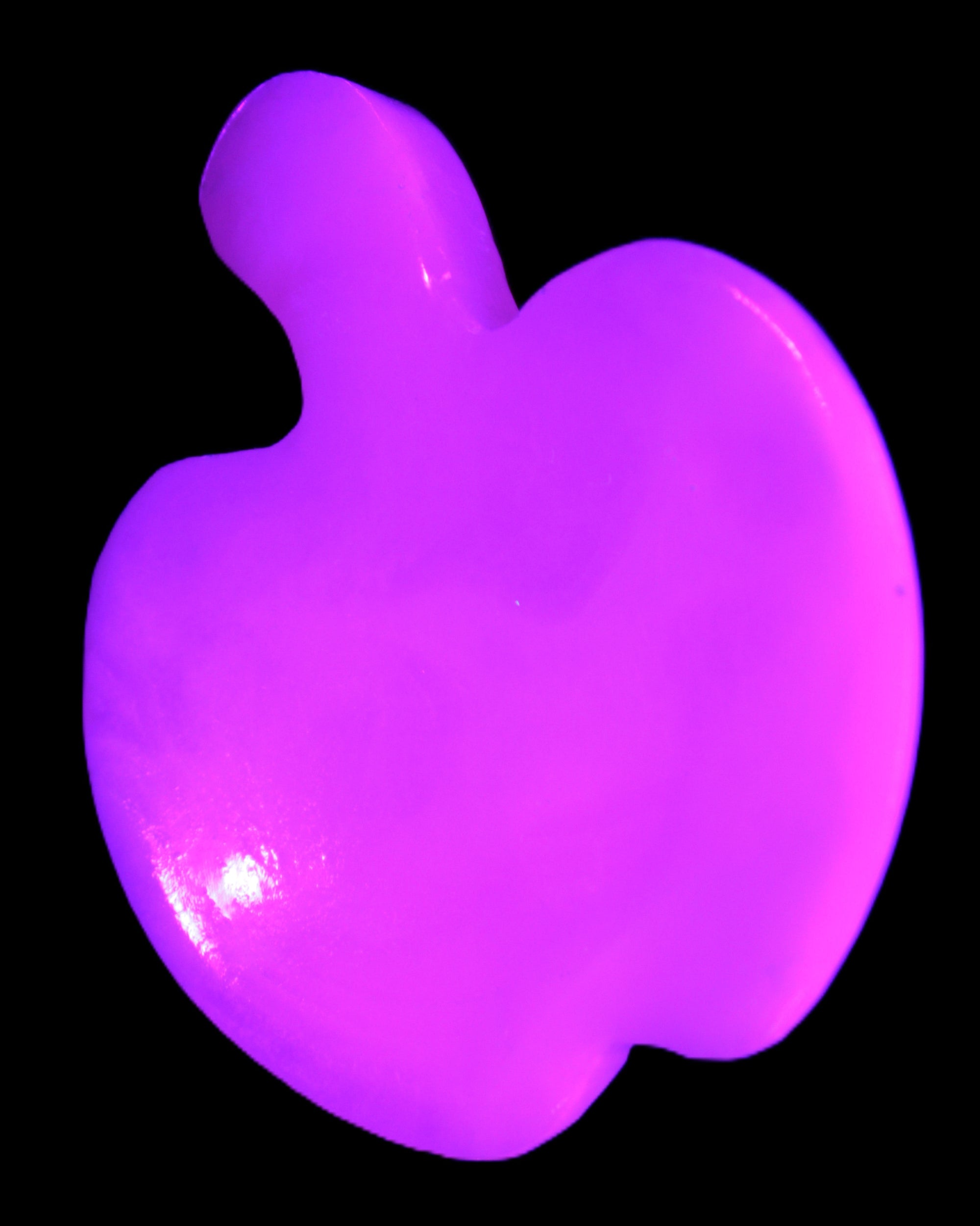 Mangano Calcite hand-carved apple 50-59g in UV light - Rocks and Things Store