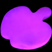 Mangano Calcite hand-carved apple 50-59g in UV light - Rocks and Things Store