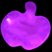 Mangano Calcite hand-carved apple 50-59g in UV light - Rocks and Things Store