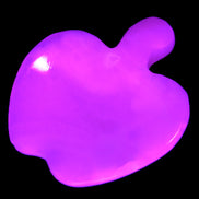 Mangano Calcite hand-carved apple 41-49g in UV light - Rocks and Things Store