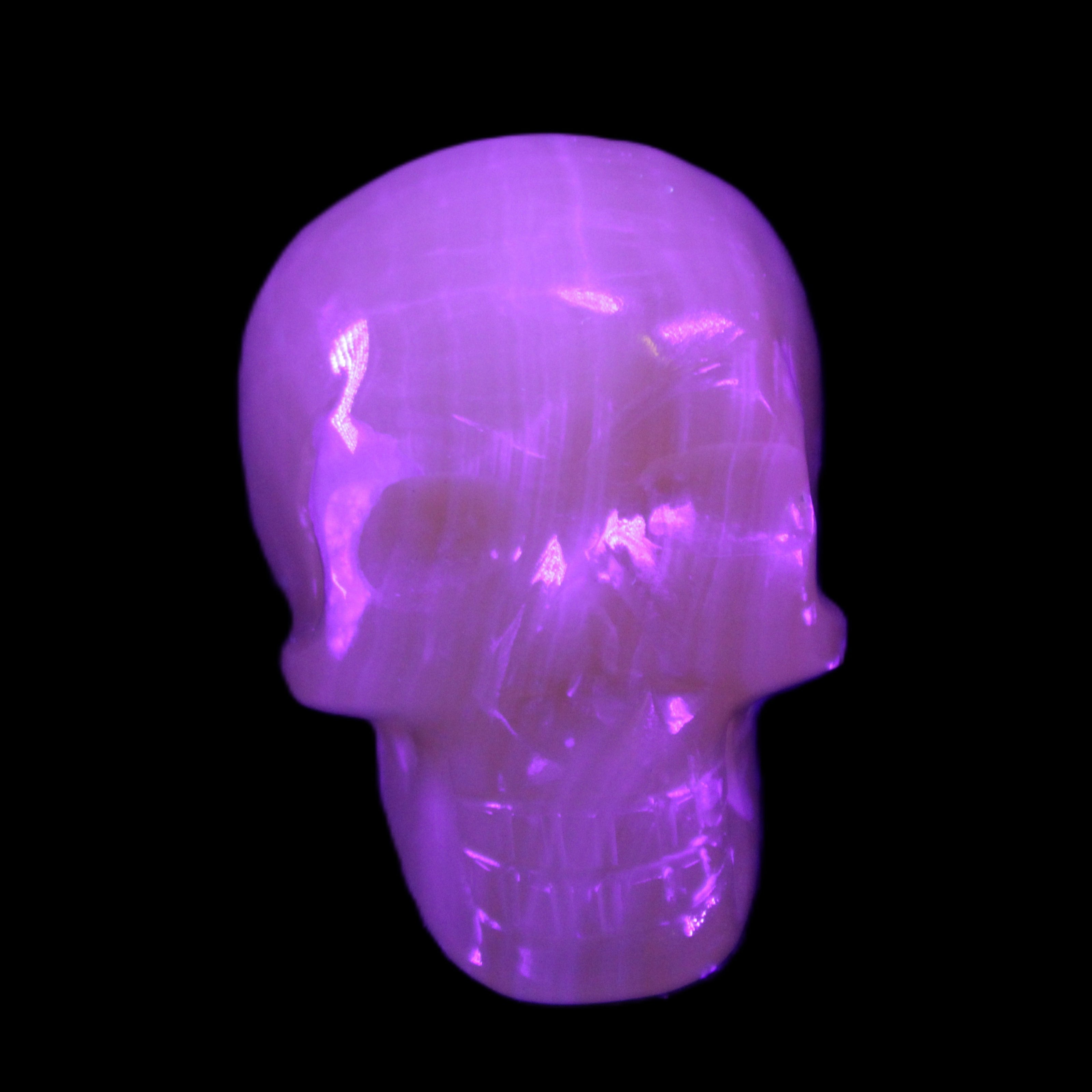 Honey Calcite skull 40*58*56mm approx., 189g in UV light - Rocks and Things Store