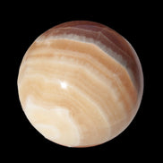Honey Calcite sphere 55mm 177g in sunlight - Rocks and Things Store