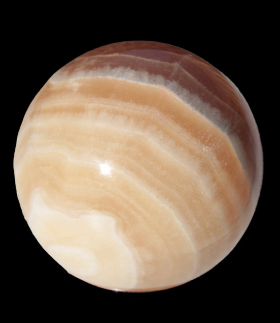 Honey Calcite sphere 55mm 177g in sunlight - Rocks and Things Store