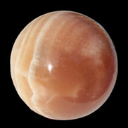 Honey Calcite sphere 55mm 177g in sunlight - Rocks and Things Store