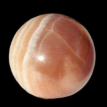 Honey Calcite sphere 55mm 177g in sunlight - Rocks and Things Store