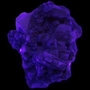 Amphitheatre Feldspar matrix with Mica and Clear Aquamarine and Quartz crystals 65g in UV light