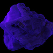 Amphitheatre Feldspar matrix with Mica and Clear Aquamarine and Quartz crystals 65g in UV light