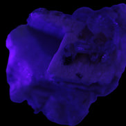 Amphitheatre Feldspar matrix with Mica and Clear Aquamarine and Quartz crystals 65g in UV light