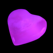 Mangano Calcite hand-carved heart 20-29g in UV light - Rocks and Things Store