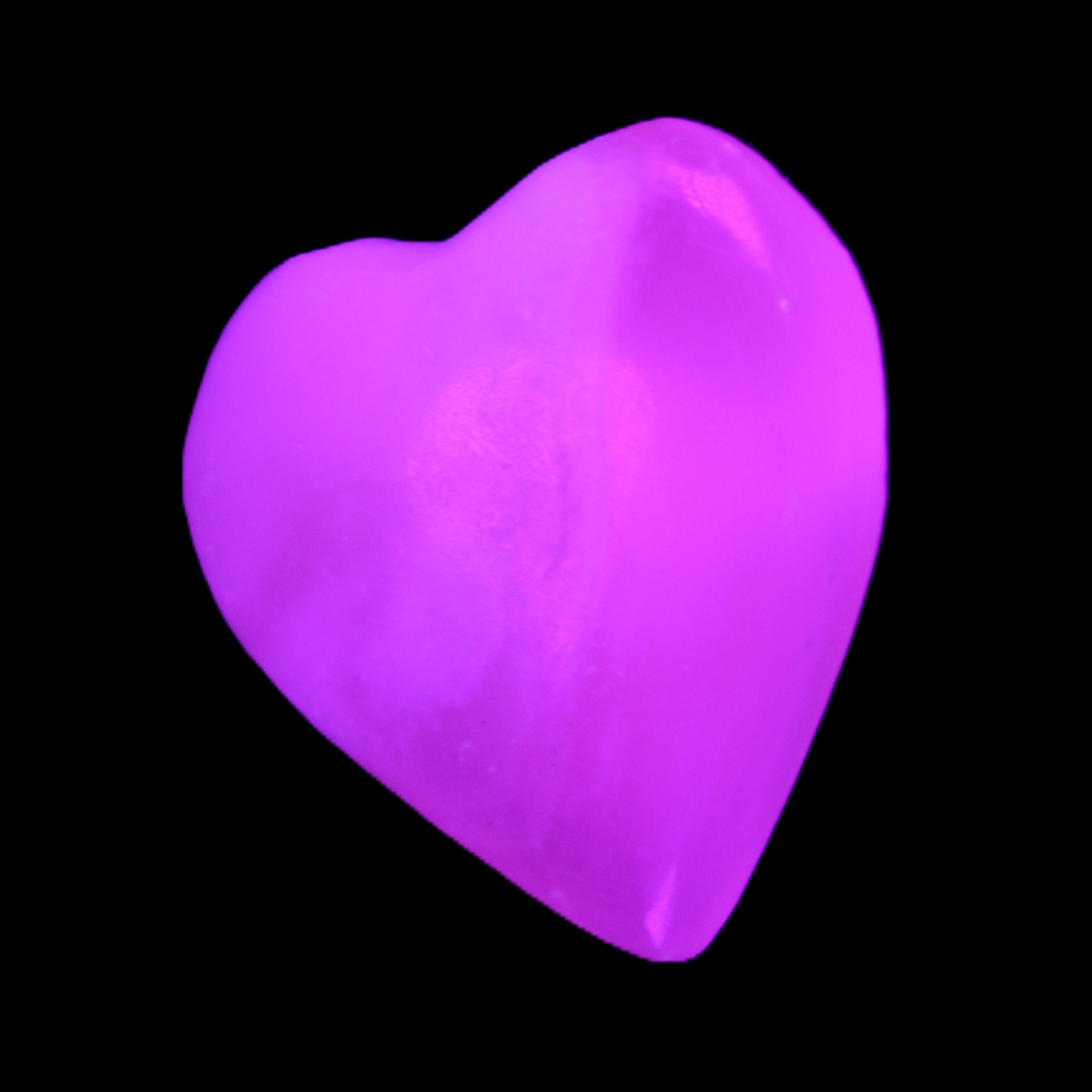 Mangano Calcite hand-carved heart 20-29g in UV light - Rocks and Things Store