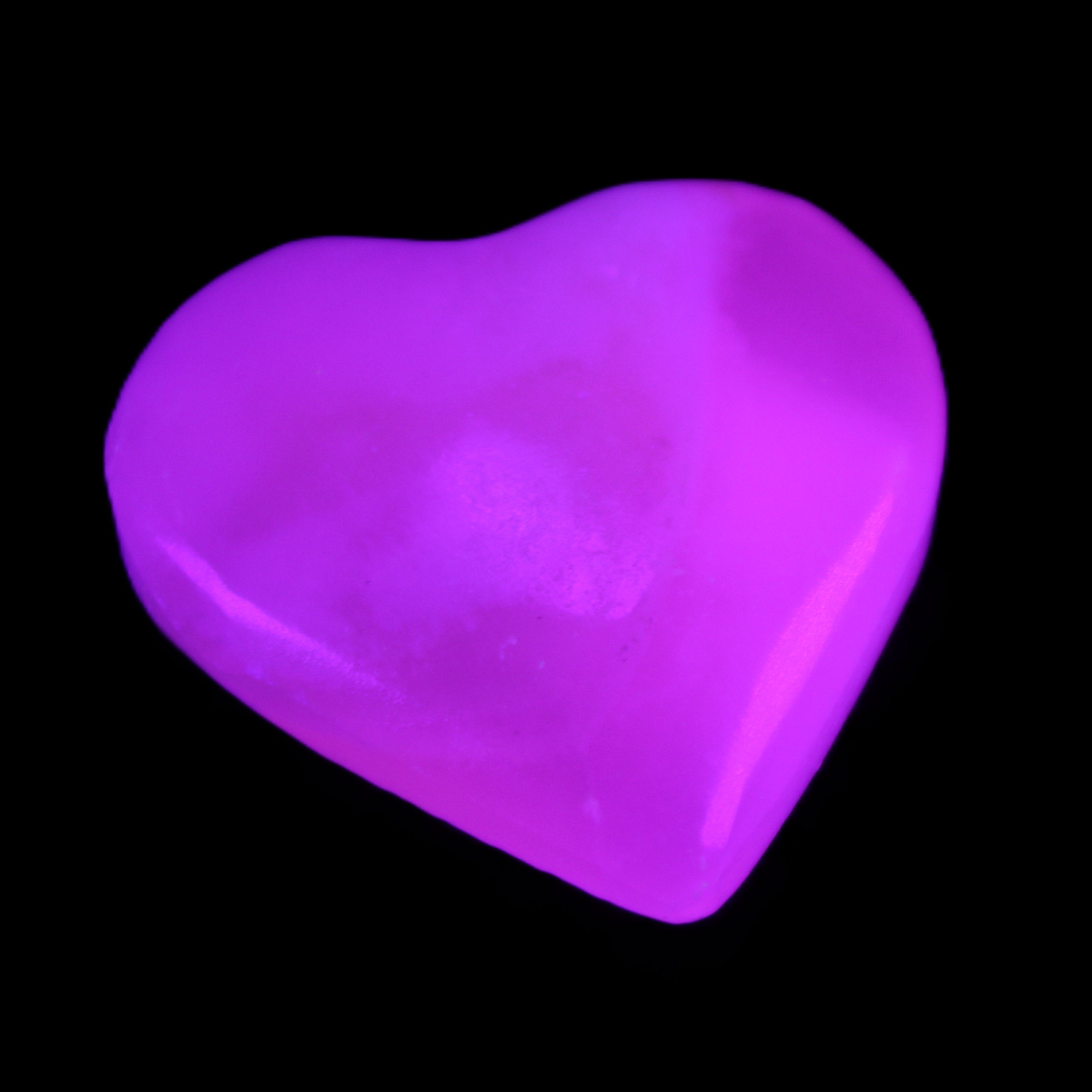 Mangano Calcite hand-carved heart 20-29g in UV light - Rocks and Things Store