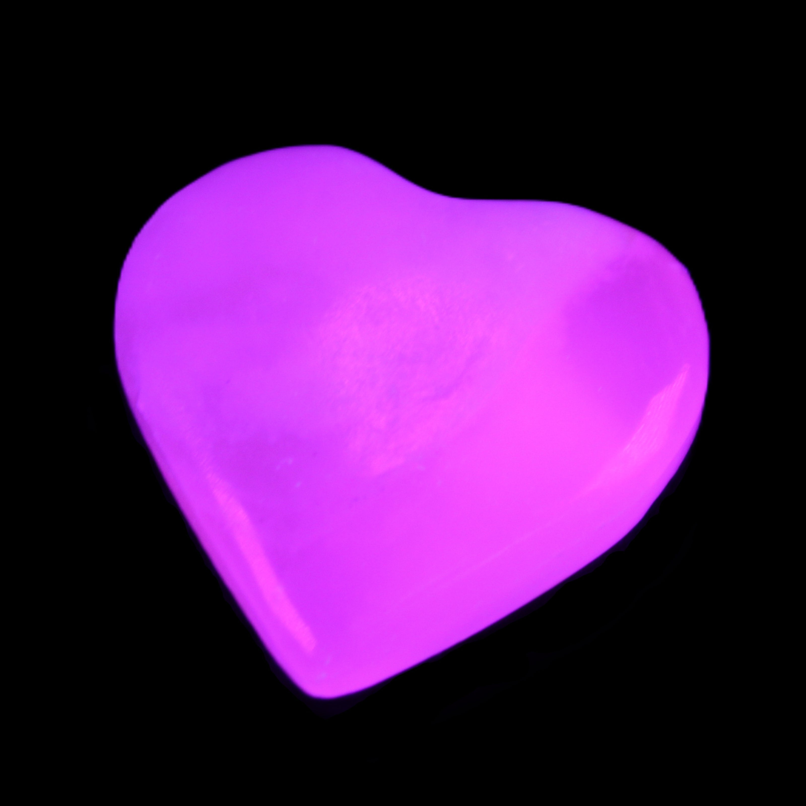 Mangano Calcite hand-carved heart 20-29g in UV light - Rocks and Things Store