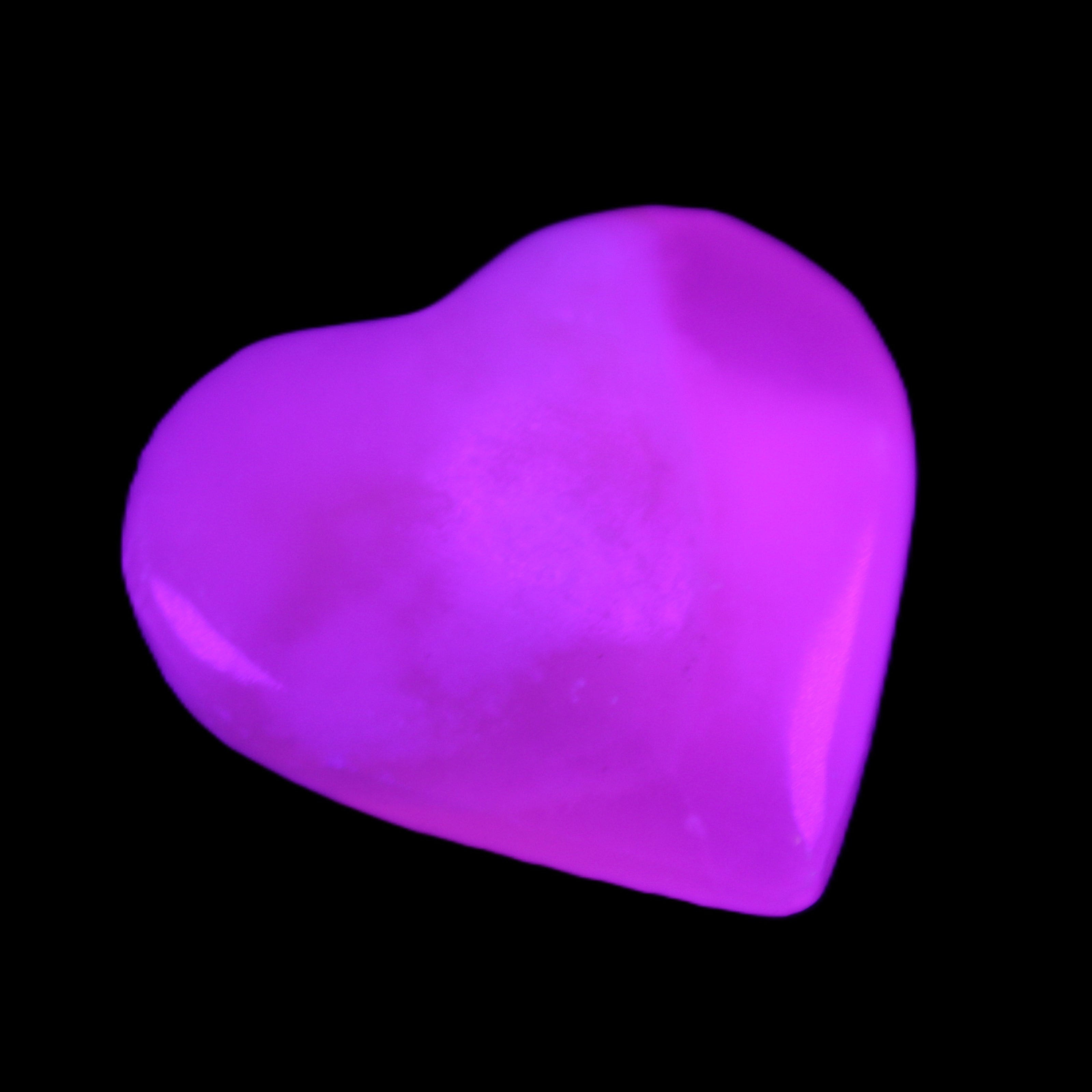 Mangano Calcite hand-carved heart 20-29g in UV light - Rocks and Things Store