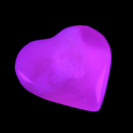 Mangano Calcite hand-carved heart 20-29g in UV light - Rocks and Things Store