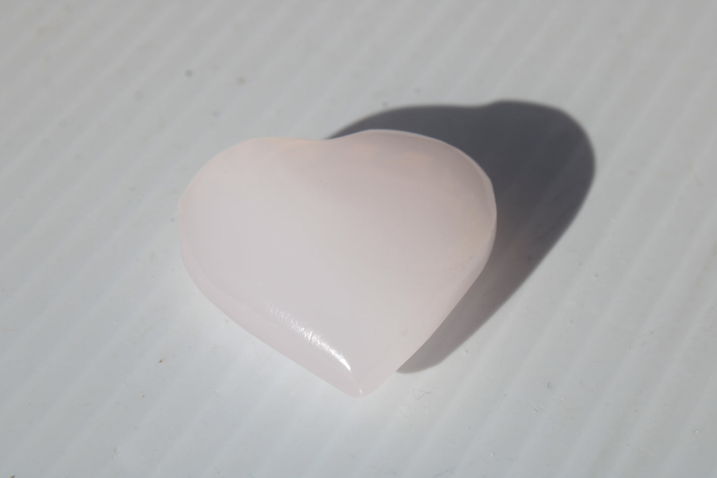 Mangano Calcite hand-carved heart 30-39g Rocks and Things