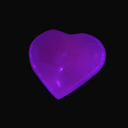 Mangano Calcite hand-carved heart 30-39g in UV light - Rocks and Things Store
