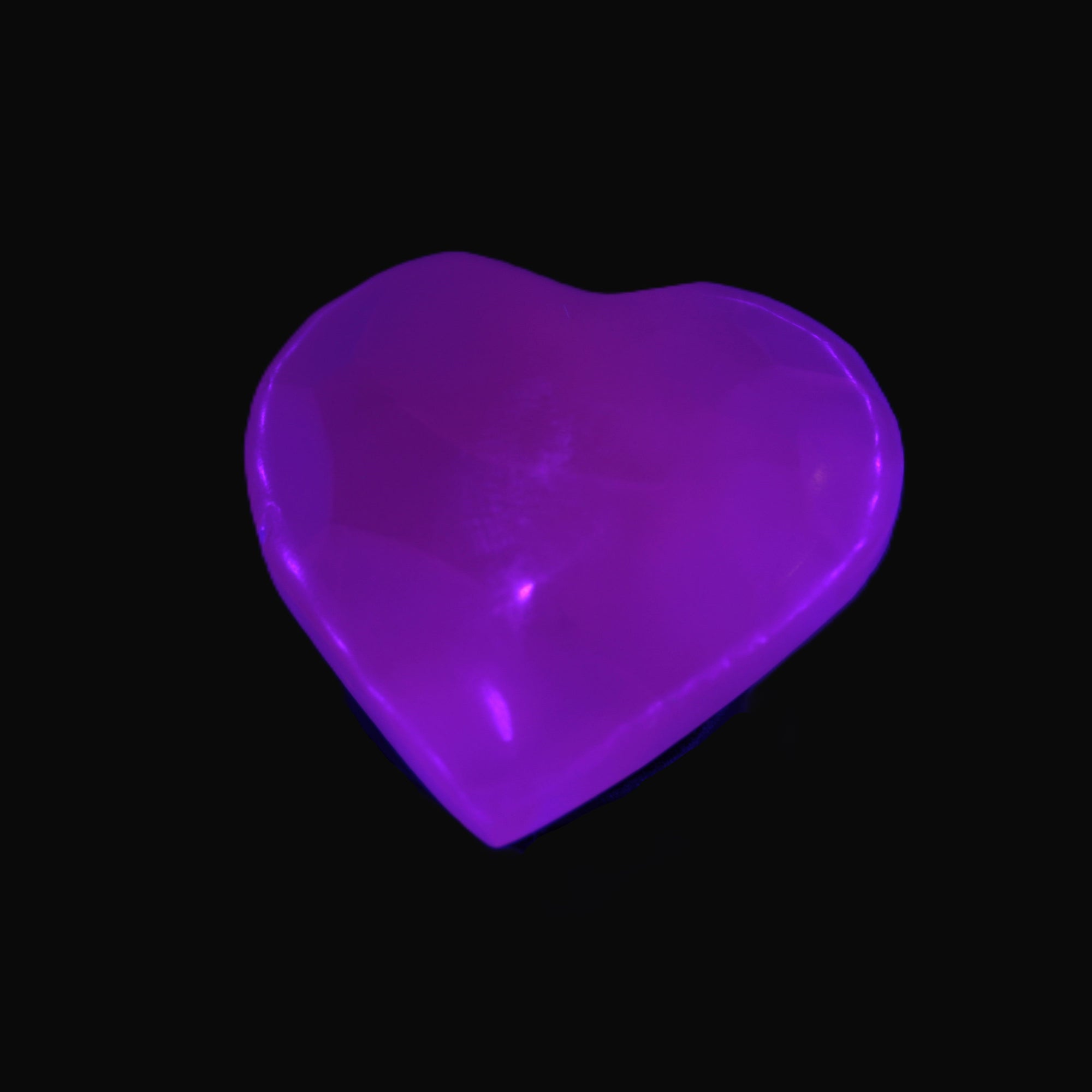 Mangano Calcite hand-carved heart 30-39g in UV light - Rocks and Things Store
