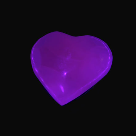 Mangano Calcite hand-carved heart 30-39g in UV light - Rocks and Things Store