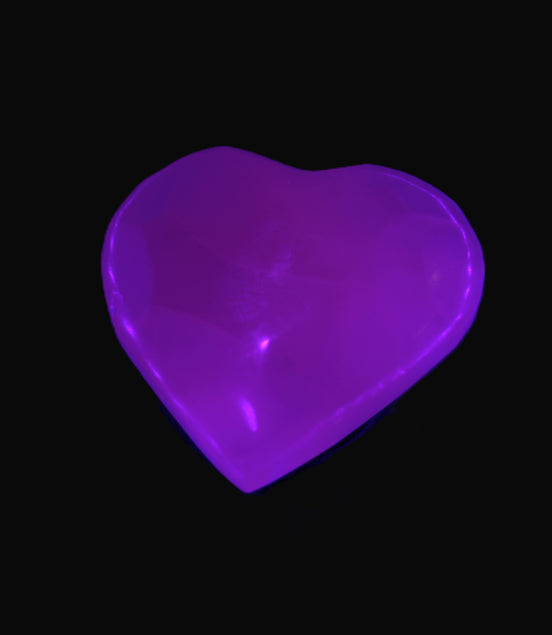 Mangano Calcite hand-carved heart 30-39g in UV light - Rocks and Things Store