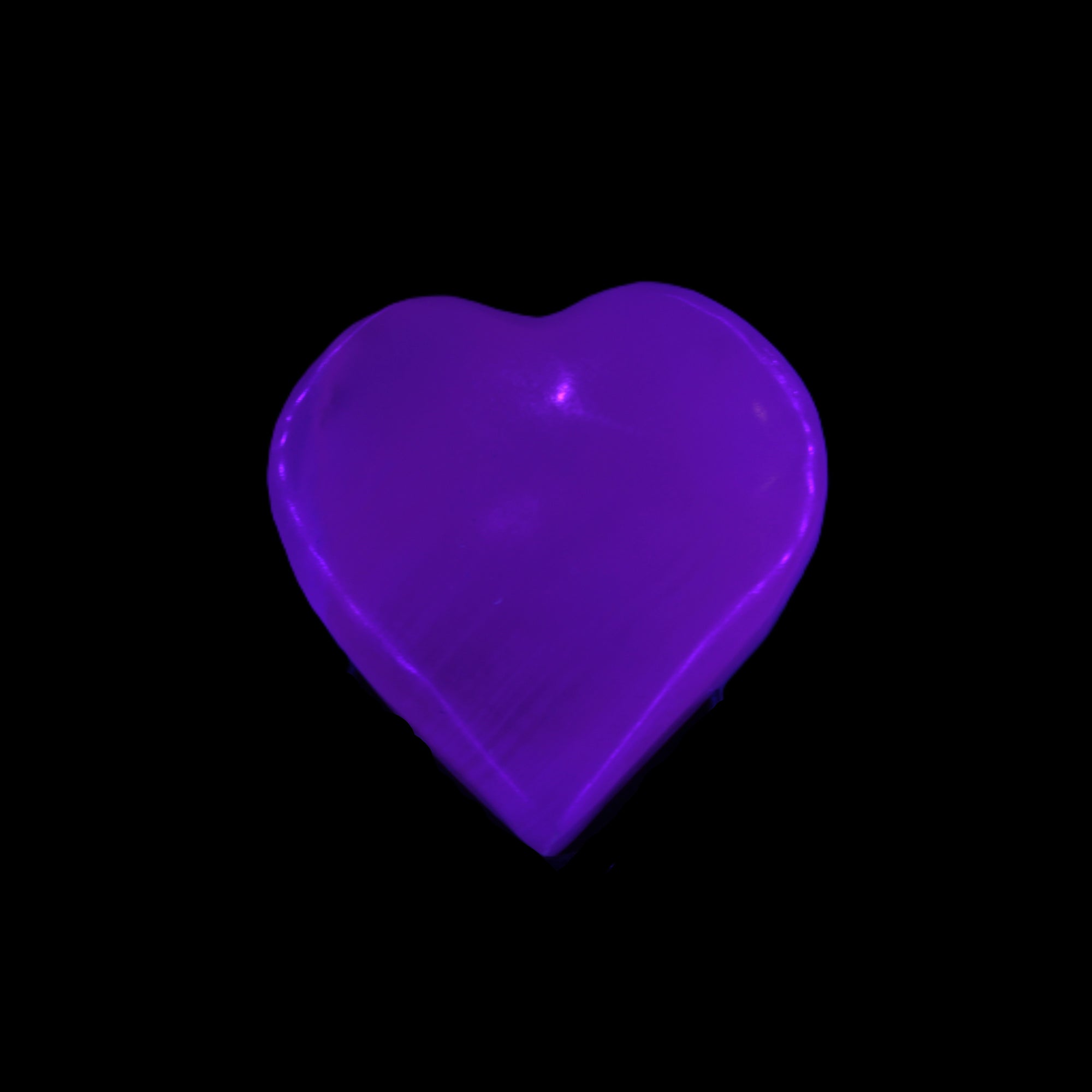 Mangano Calcite hand-carved heart 30-39g in UV light - Rocks and Things Store