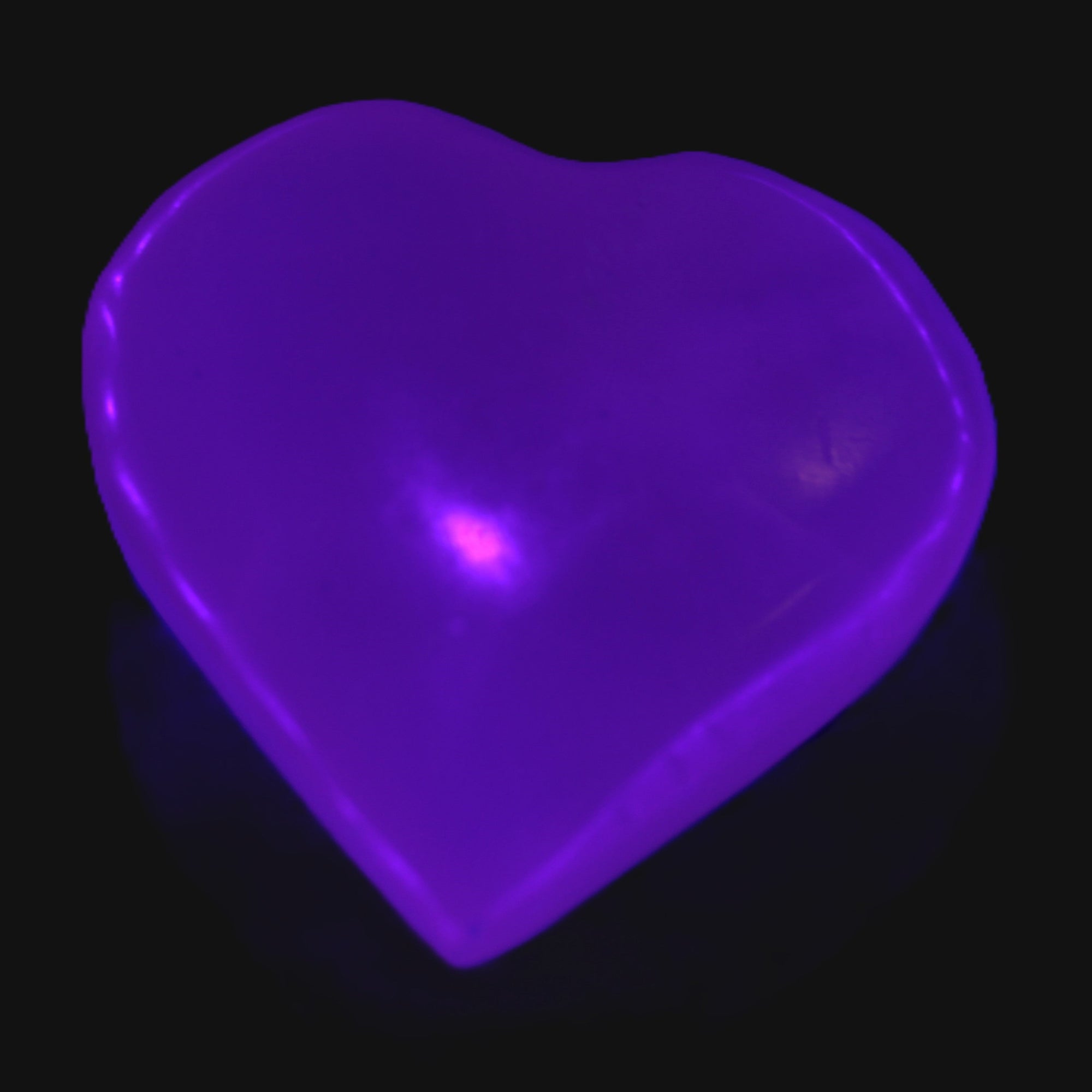 Mangano Calcite hand-carved heart 30-39g in UV light - Rocks and Things Store