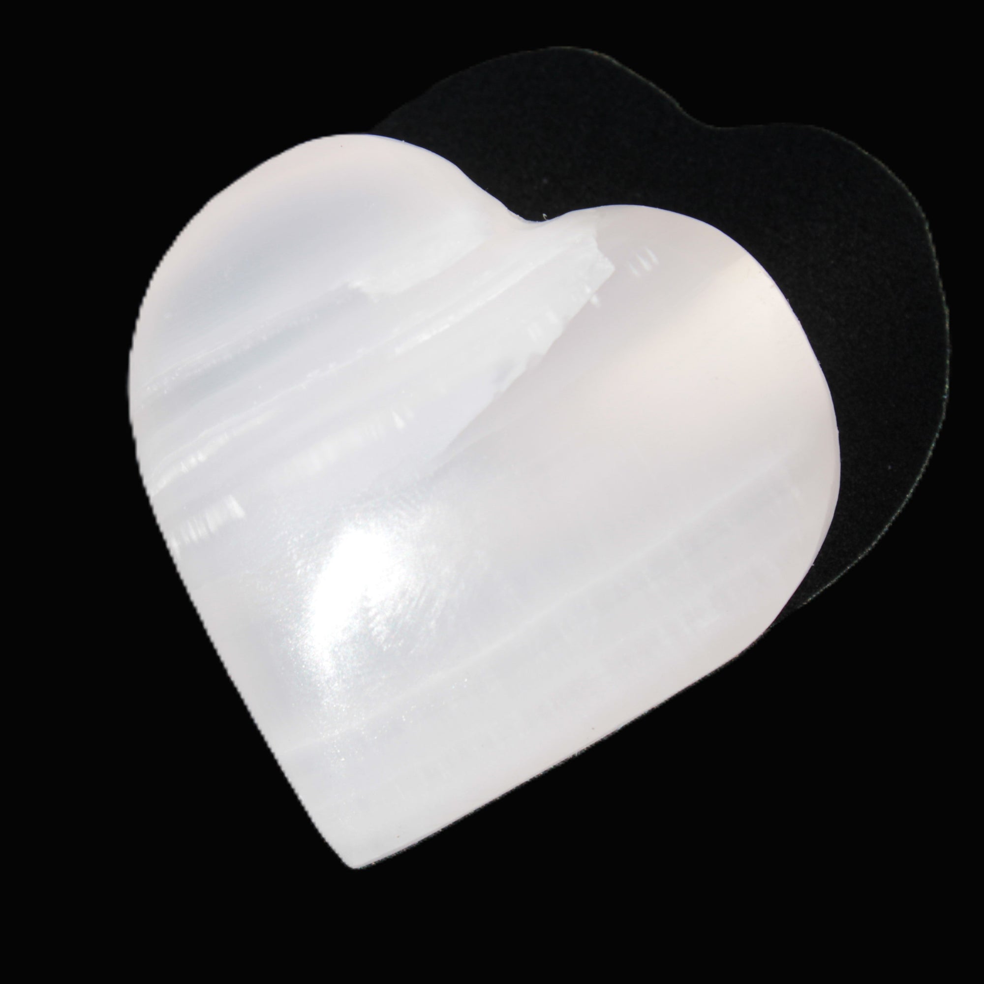 Mangano Calcite hand-carved heart 30-39g in sunlight - Rocks and Things Store