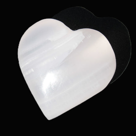 Mangano Calcite hand-carved heart 30-39g in sunlight - Rocks and Things Store