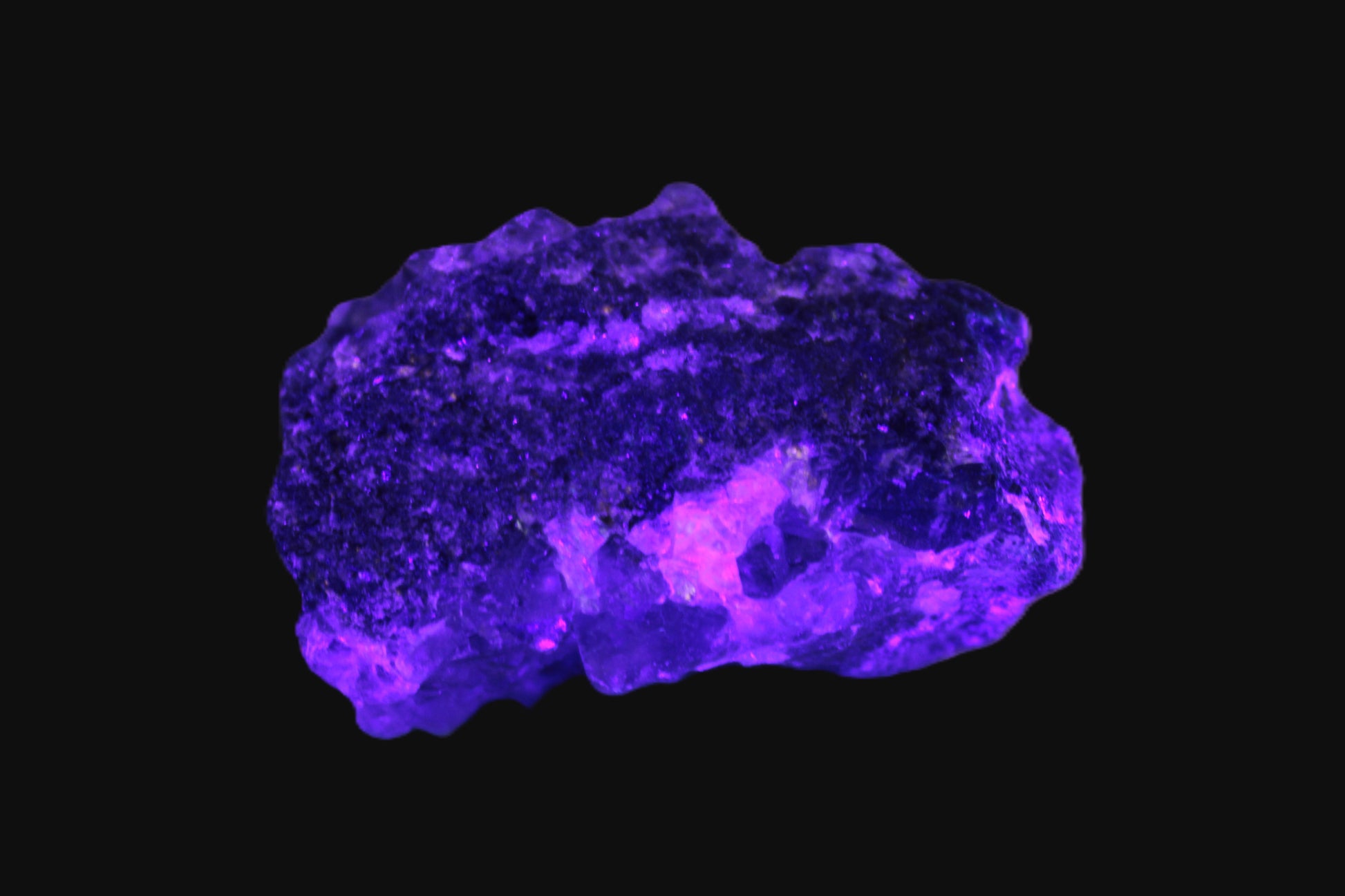 Clear Fluorite with UV reactive mica matrix in UV light