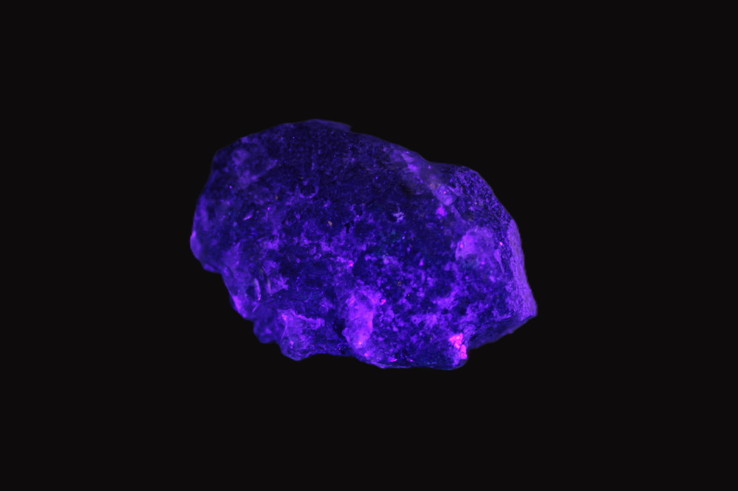 Clear Fluorite with UV reactive mica matrix in UV light