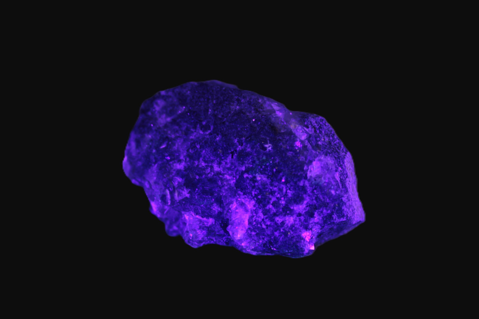 Clear Fluorite with UV reactive mica matrix in UV light