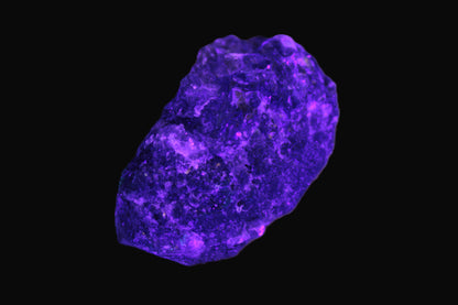 Clear Fluorite with UV reactive mica matrix in UV light