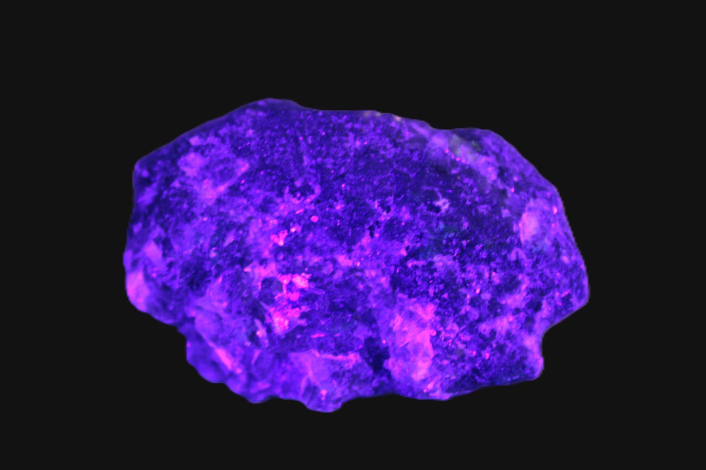 Clear Fluorite with UV reactive mica matrix in UV light