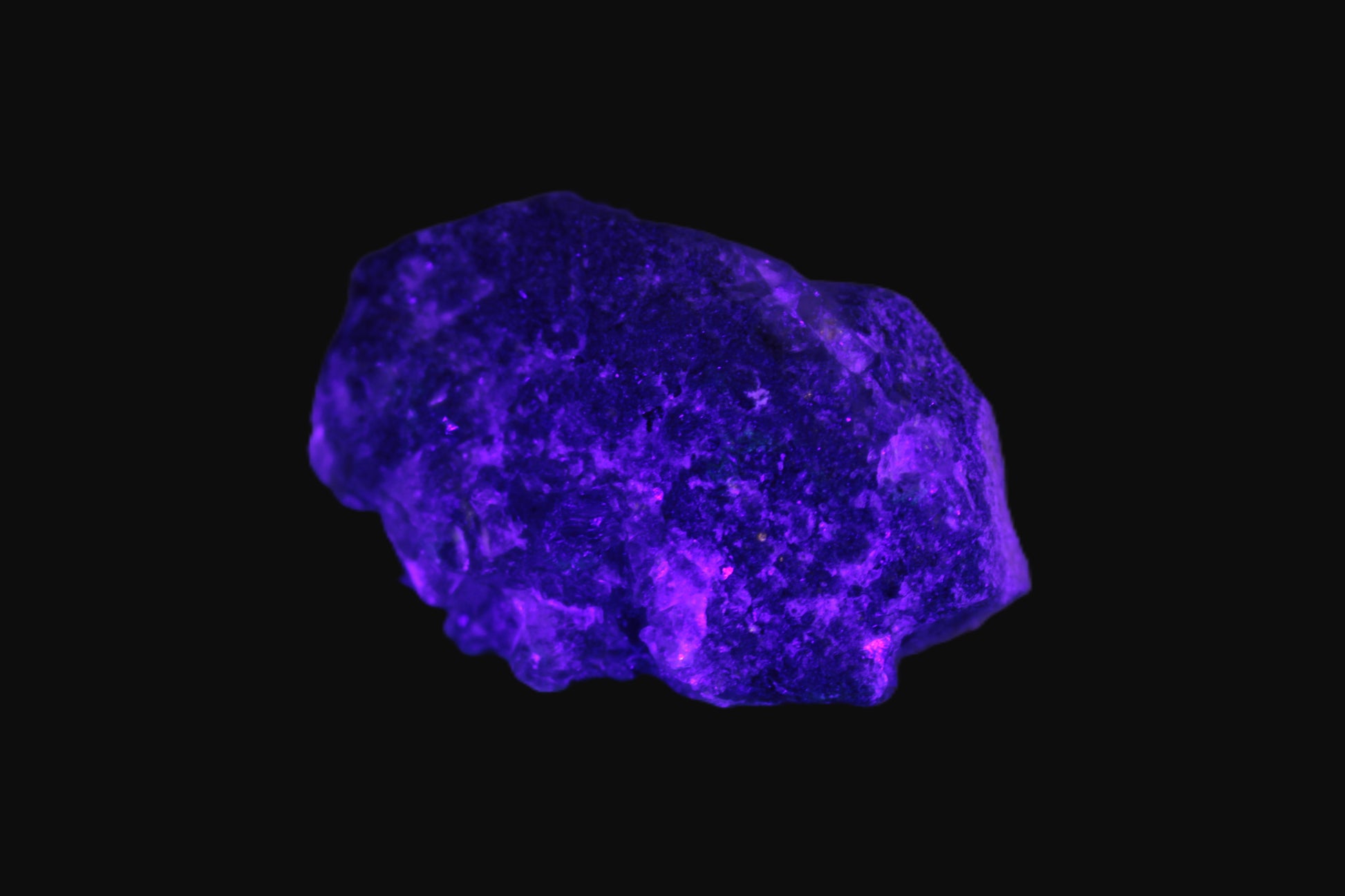 Clear Fluorite with UV reactive mica matrix in UV light