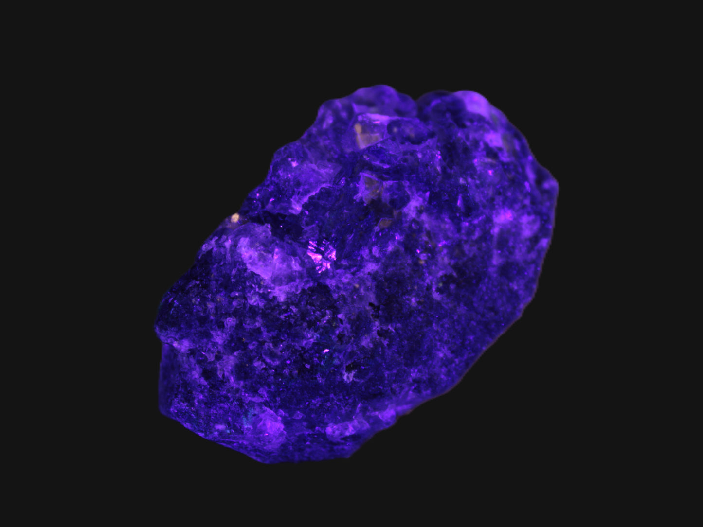 Clear Fluorite with UV reactive mica matrix in UV light