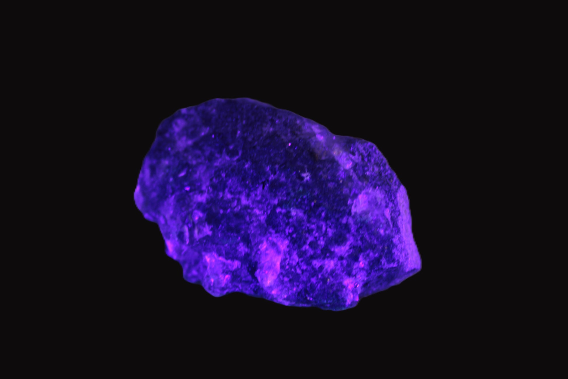 Clear Fluorite with UV reactive mica matrix in UV light