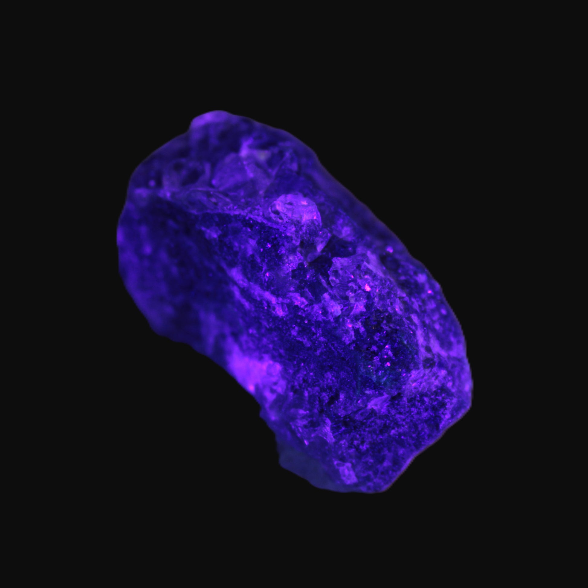 Clear Fluorite with UV reactive mica matrix in UV light