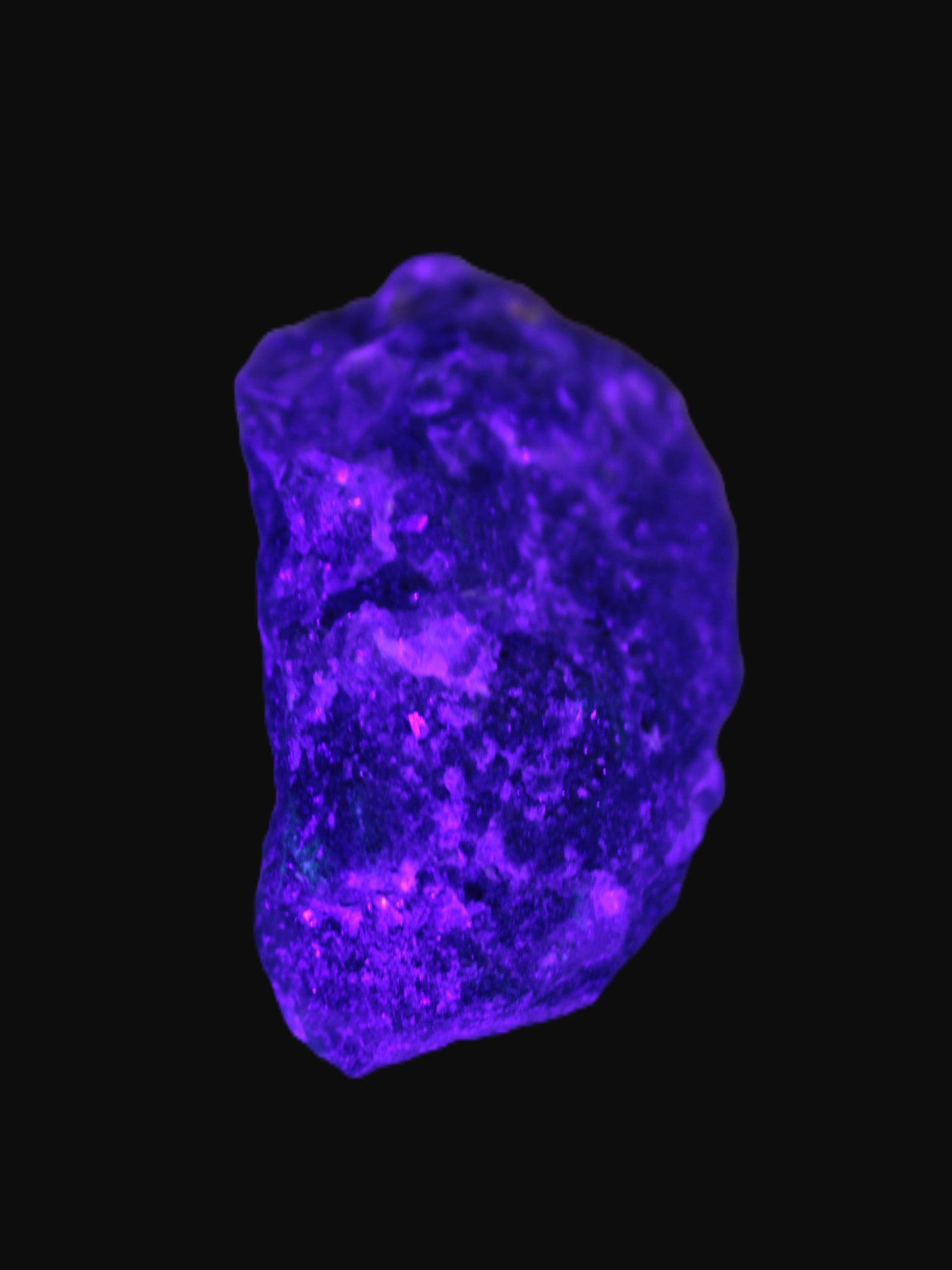 Clear Fluorite with UV reactive mica matrix in UV light