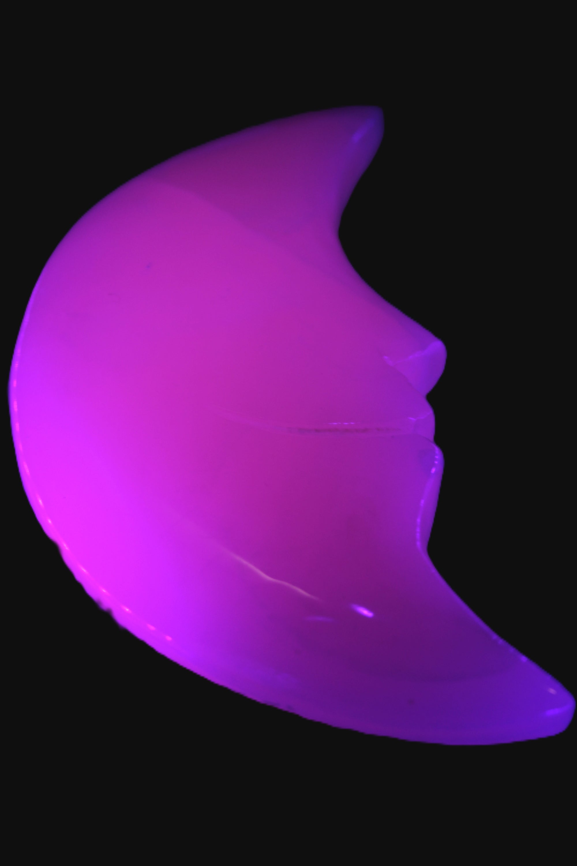Mangano Calcite smiling Crescent Moon 70*132.22mm 331g in UV light  - Rocks and Things Store