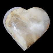Mangano Calcite hand-carved heart 66/67*64/70mm 130-136g in sunlight - Rocks and Things Store