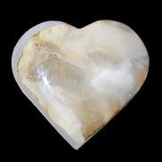 Mangano Calcite hand-carved heart 66/67*64/70mm 130-136g in sunlight - Rocks and Things Store