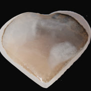 Mangano Calcite hand-carved heart 67-94mm  129-274g in sunlight - Rocks and Things Store