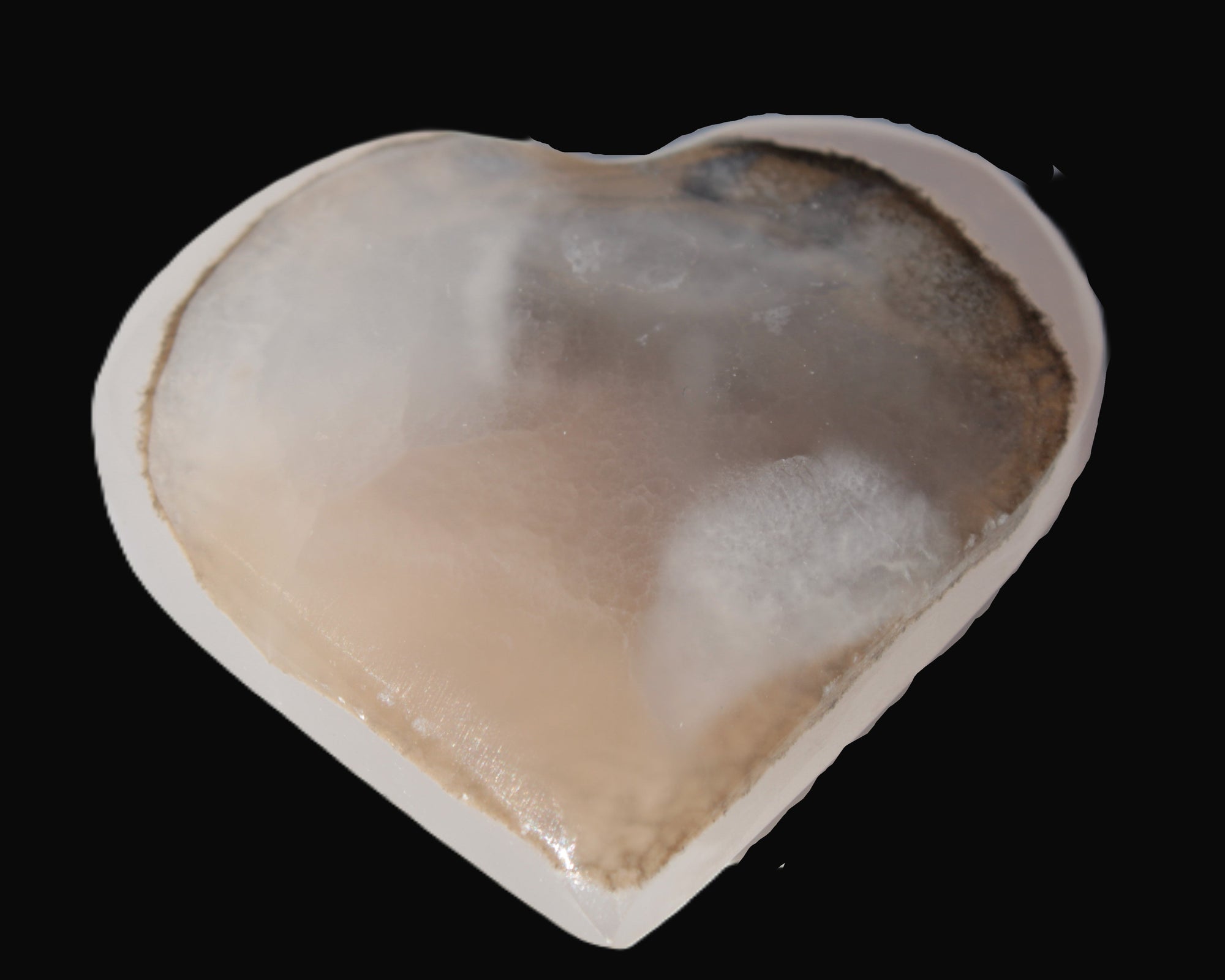 Mangano Calcite hand-carved heart 67-94mm  129-274g in sunlight - Rocks and Things Store